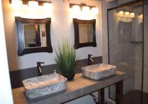 two sinks in a bathroom with two mirrors at Rivers Edge Lofts - Unit 9 in Niles +23 photos