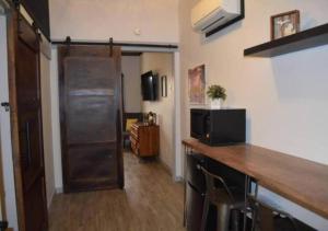 a room with a kitchen with a counter and a microwave at Rivers Edge Lofts - Unit 9 in Niles