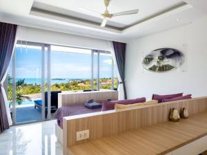 a bedroom with a bed with a view of the ocean at Luxe 4BR Sunset Seaview Villa Private Infinity in Plai Laem +42 photos