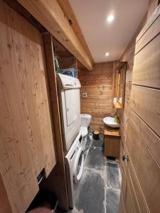a small bathroom with a toilet and a sink at Les Racines Chalet in Villard-Reculas +61 photos