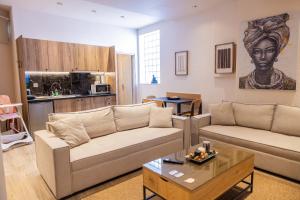 a living room with two couches and a table at Omega Suites 31 in Tríkala