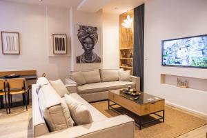 a living room with a couch and a table at Omega Suites 31 in Tríkala