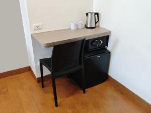 a black desk with a coffee maker on top of it at Red Planet Cagayan De Oro in Cagayan de Oro