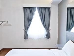 a bedroom with a bed and a window at Red Planet Cagayan De Oro in Cagayan de Oro