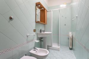 a bathroom with a sink and a toilet and a shower at Penthouse Magic View - Large penthouse in the center in Oristano +30 photos