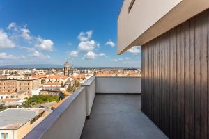 a balcony with a view of a city at Penthouse Magic View - Large penthouse in the center in Oristano