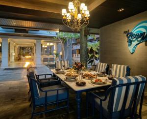 a dining room with a table with food on it at Rest Detail Hotel Hua Hin in Hua Hin
