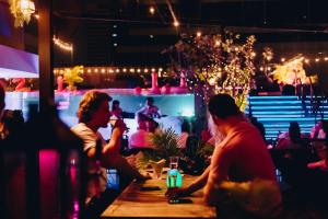 a group of people sitting at a bar at Tastoria Collection Sukhumvit in Bangkok +73 photos