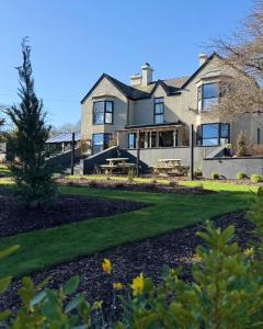 a large house with a landscaped yard at The Tall Trees Hotel in Amlwch
