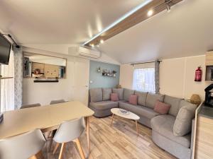 a living room with a couch and a table at casa Laetitia in Lège-Cap-Ferret