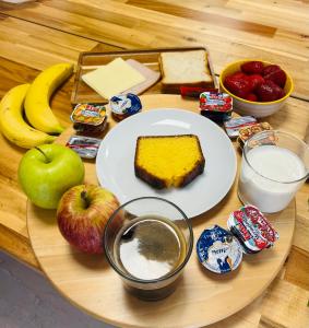 a table with a plate of cake and apples and other snacks at Ipsos Beach Studios by Konnect in Ipsos
