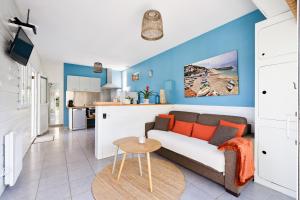 a living room with a couch and a table at chambres d'hôtes villa OZ in Bidart