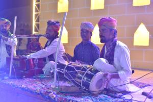 a group of men sitting on a stage playing music at Sunrise Resort Jaislamer in Jaisalmer +27 photos