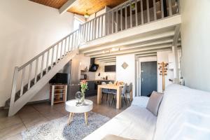 a bedroom with a large bed and a staircase at Le Donjon - Agréable T2 centre ville - parking gratuit 2 min - in Mont-de-Marsan