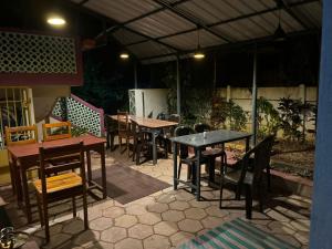 a group of tables and chairs in a patio at Artham The River View in Gokarna