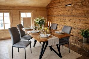 a dining room with a wooden table and chairs at Ap1 20 min to Interlaken in Frutigen