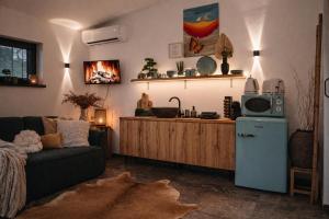 a living room with a couch and a kitchen at Záhradný domček pri Slovenskom raji in Smižany