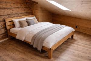 a bedroom with a bed in a log cabin at Ap1 20 min to Interlaken in Frutigen