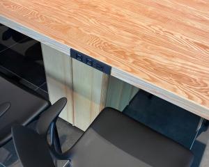 a wooden desk with a black chair under it at Heiwadai Hotel 5 in Fukuoka