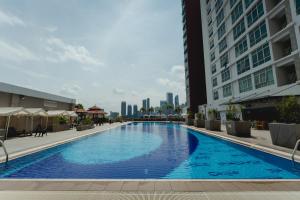 a large swimming pool in the middle of a building at UTM Hotel & Residence in Kuala Lumpur