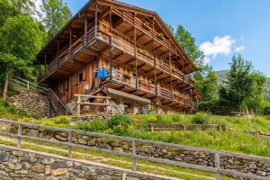 a large wooden house on top of a hill at Chalet Panorama Rabbi By Immobilux in Rabbi