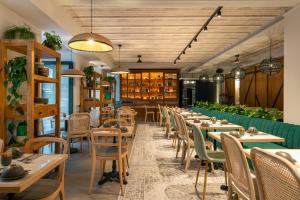 a restaurant with wooden tables and chairs and books at Pestana Rua Augusta Lisboa in Lisbon