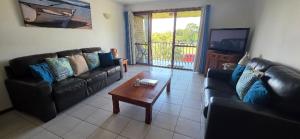 a living room with two couches and a coffee table at Spacious - Sunrise over the sea in Urangan