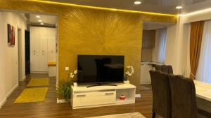 a living room with a flat screen tv on a stand at ZBI Apartament in Oradea