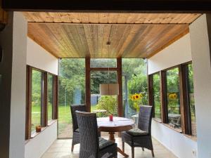 a dining room with a table and chairs and windows at Zum Schafstall in Hünxe