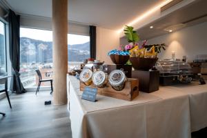 a table with clocks on it in a room at Hotel Albergo Milano in Mendrisio