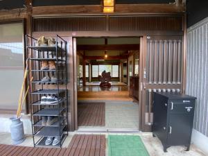 an open door of a house with a shelf at Hostel Kumano Kodo in Tanabe