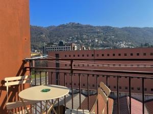 a table and chairs on the balcony of a building at White Noise Como - Private Room in Como