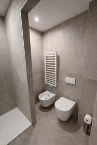 a bathroom with a toilet and a sink at R Platano House in Como