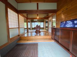 a room with a statue in the middle of a room at Hostel Kumano Kodo in Tanabe