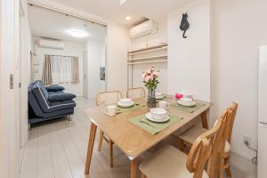 a dining room and living room with a table and chairs at japan house Otsuka in Tokyo