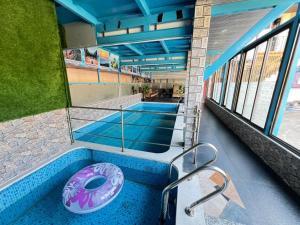 a swimming pool with a donut in the middle at Saanjh Riverside Resort in Mahabaleshwar