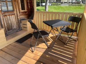 a table and two chairs sitting on a porch at EuroParcs Hermagor - Nassfeld in Hermagor