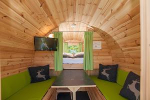 a room with a bed and a tv in a wooden cabin at EuroParcs Hermagor - Nassfeld in Hermagor