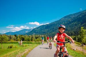 a young child riding a bike on a trail at EuroParcs Hermagor - Nassfeld in Hermagor