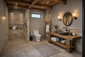 a bathroom with a sink and a toilet and a mirror at Your Sanctuary in Kasese