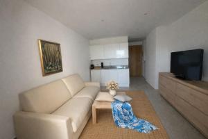 a living room with a couch and a tv at Villa MARINE in Ersa