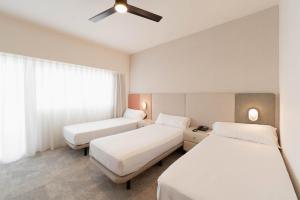 a hotel room with two beds and a ceiling fan at Hotel RH Royal - Recommend for adults in Benidorm +31 photos