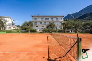 a tennis court in front of a building at Hotiday Malcesine Garda in Malcesine