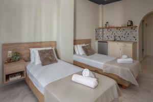 a room with two beds and a kitchen at Argo Cozy Studios by Estia in Malia