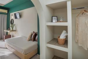 a small bedroom with a bed and shelves at Argo Cozy Studios by Estia in Malia