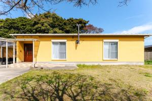 a yellow house with a driveway at Shimabara 結 Terrace in Shimabara