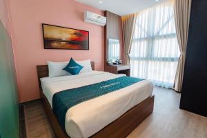 a bedroom with a large bed in a room at X-Men Hotel Thanh Hoa - Not Near Sam Son Beach in Thanh Hóa