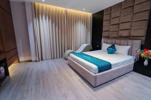 a bedroom with a bed and a chair in it at X-Men Hotel Thanh Hoa - Not Near Sam Son Beach in Thanh Hóa