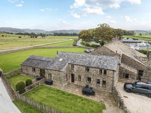 an aerial view of a stone house with a yard at Orcaber Farm Barn in Lancaster