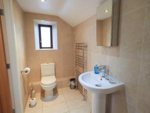 a bathroom with a toilet and a sink at Orcaber Farm Barn in Lancaster +30 photos